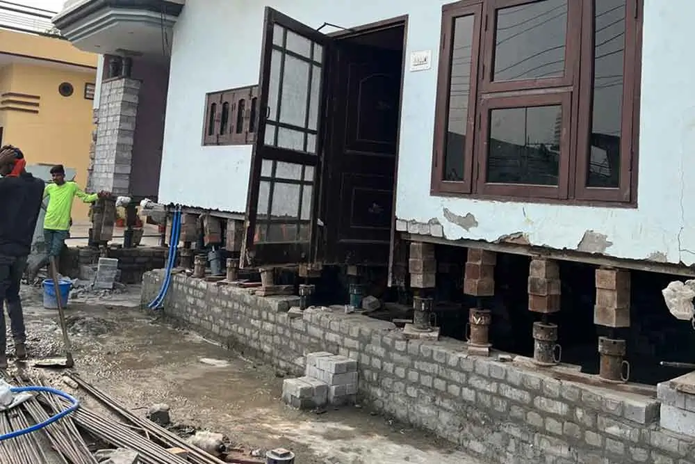 SRBL house lifting service in Kolkata using advanced hydraulic jacks to elevate a concrete structure – ensuring safety, stability, and flood protection.