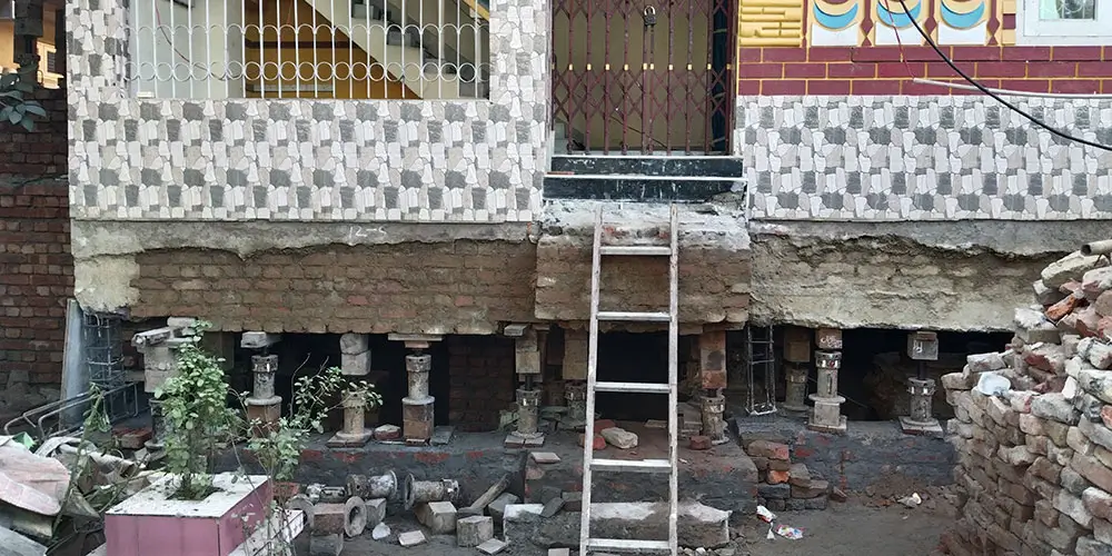 SRBL house lifting service showcasing brickwork and balcony structure during professional house elevation